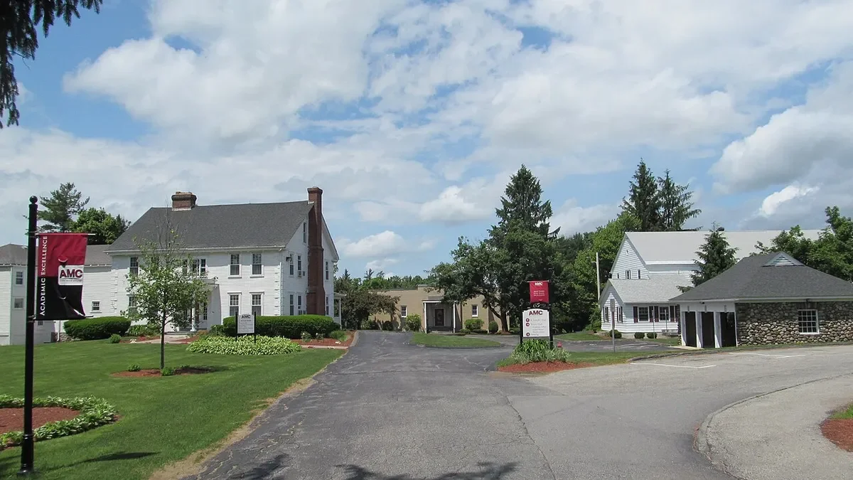 Broad view of housing structures on college campus with signage.